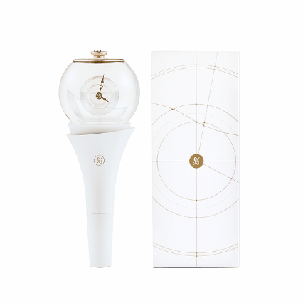 White light stick with gold accents next to its packaging on a white background