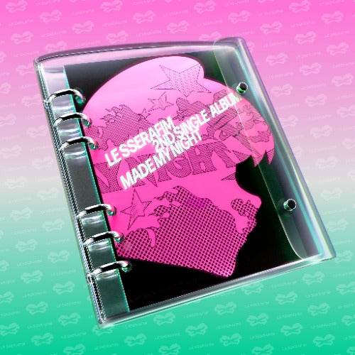 A clear plastic binder sleeve holding a pink and black album-style notebook with silver metal rings, shown on a pink-to-teal gradient background with repeated faint LE SSERAFM branding.