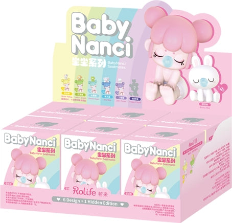 Display box of Baby Nanci toys with a pink character and packaging.