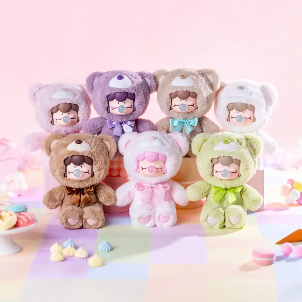 Set of colorful plush toys with cartoon faces on a pastel background