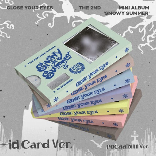 Stack of colorful mini albums with 'Close Your Eyes' text on a gray background