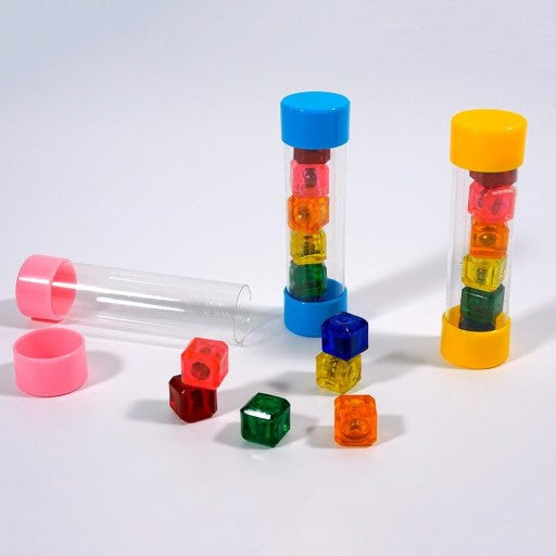 A set of colorful jackstones in various bright colors, including red, blue, green, orange, and yellow, are displayed alongside their transparent storage tubes on a white background.