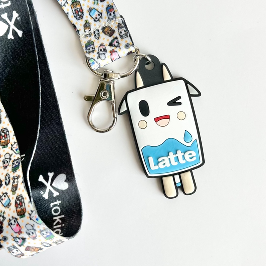 Image shows lanyard with 'tokidoki' design and name with 'milk carton' like charm on a white background.