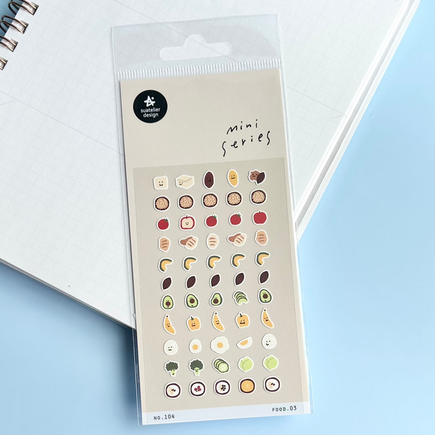 Sheet of mini food-themed stickers in a clear package on a light blue background
