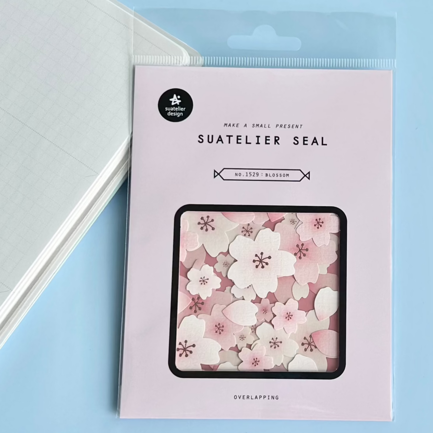 Packaging of Suatelier Seal with floral design on a light blue background