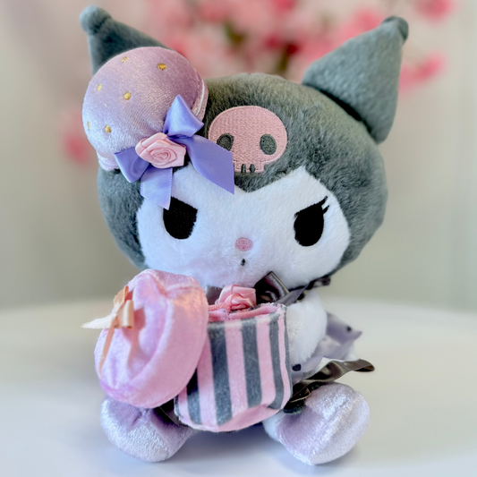 Plush toy with skull design and pink accessories on a white background