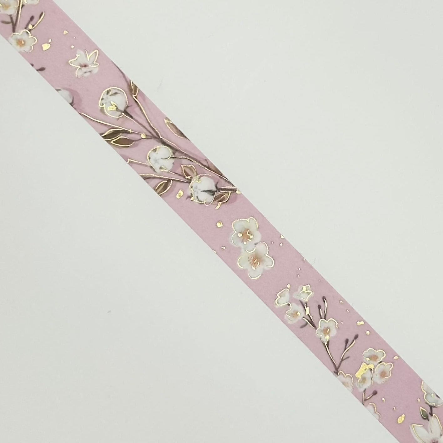 washi tape with blossom design and lavender background with gold foil accent.