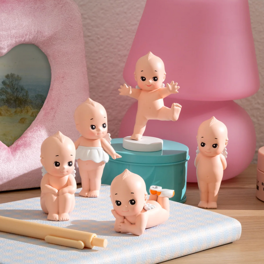 Set of baby figurines with a pink lamp in the background