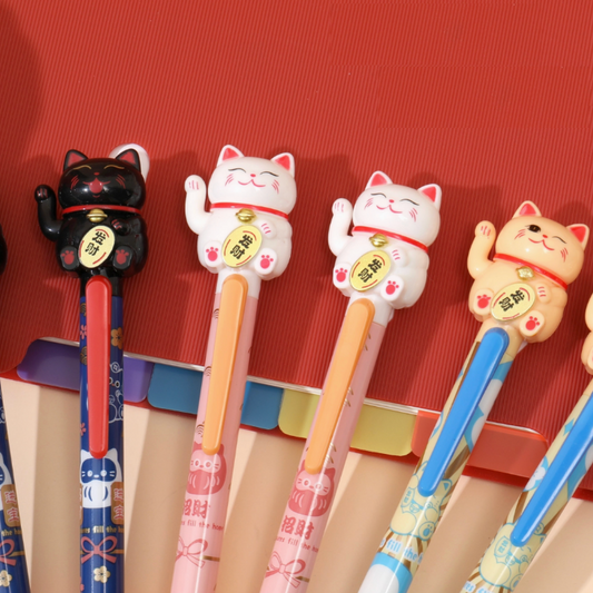 Set of pens with lucky cat-shaped figure on a red background