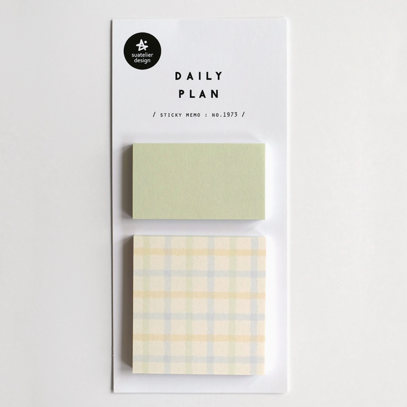Two small sticky note pads with different designs on a white background