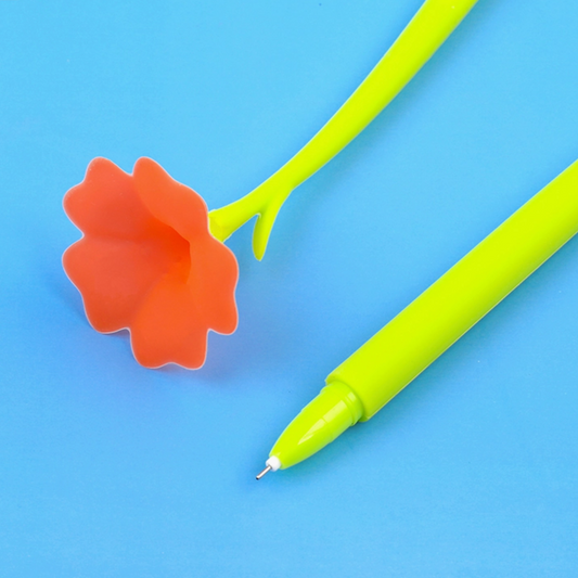 Green pen with orange flower-shaped clip on a blue background