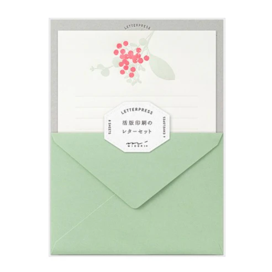 Green envelope with a white card featuring floral design and 'Letterpress' label on a white background