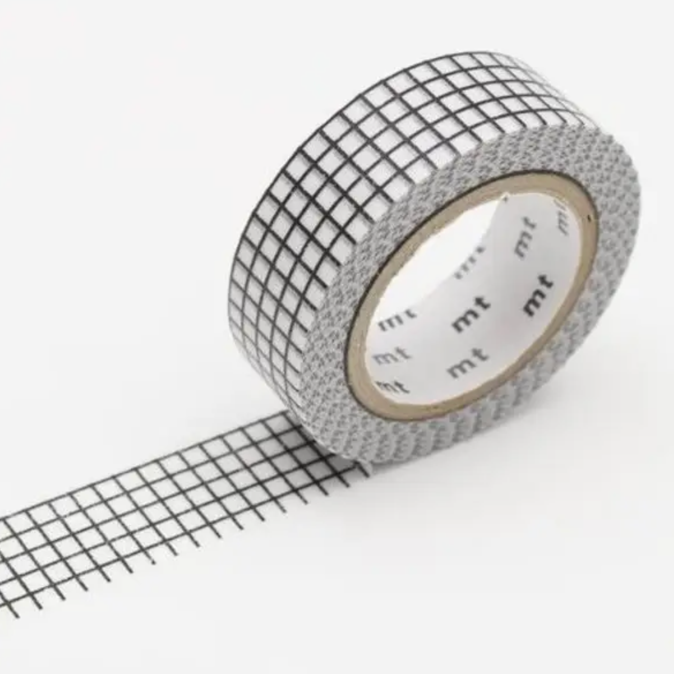 Roll of grid-patterned tape with 'mt' branding on a white background