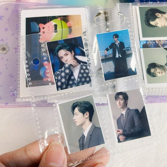 Collection of photos in a transparent photo album held by a hand.