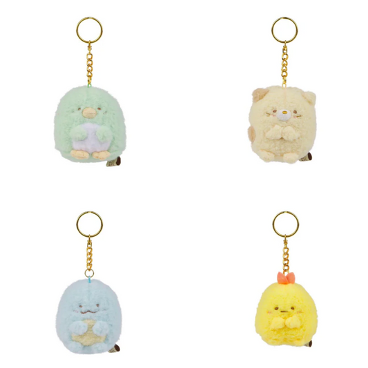 Four small plush keychains on a white background