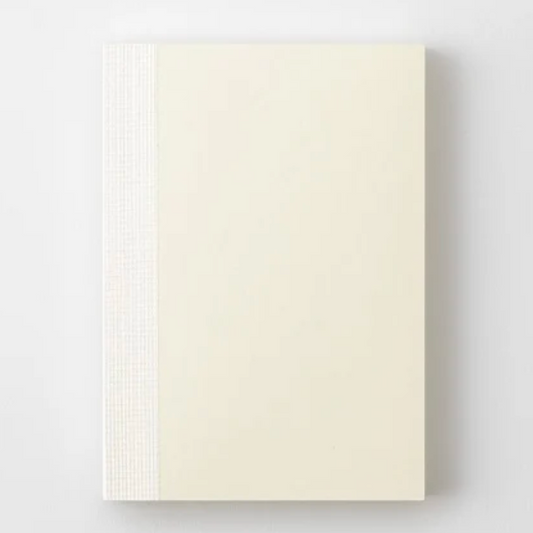Beige color notebook on a light gray background
