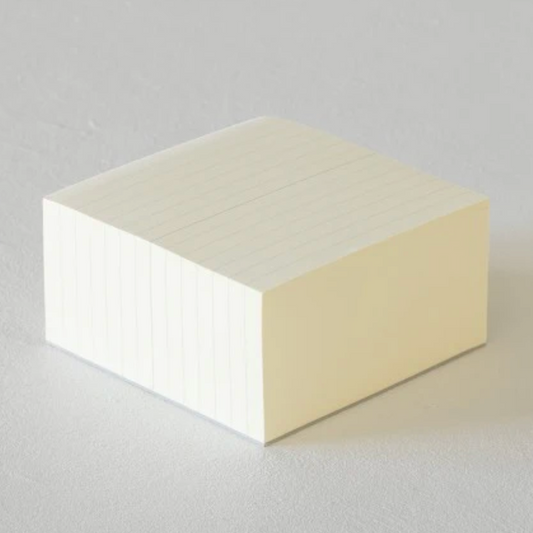 Two-tone cube-shaped block on a light gray background