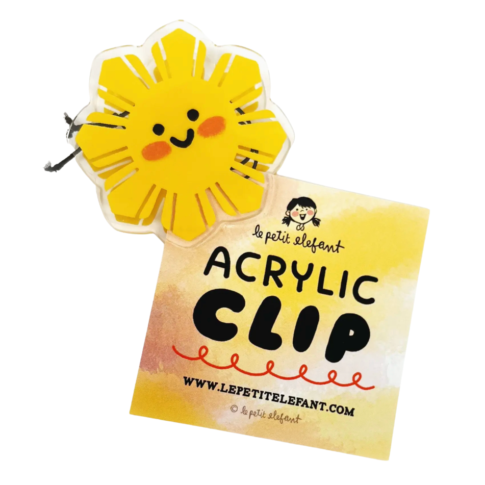 Acrylic clip with a sun design on a white background