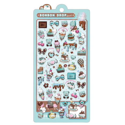 A sheet of cute pastel stickers featuring cartoon characters and dessert-themed illustrations, including ice cream cones, cakes, bows, and chocolates, on a light blue backing card labeled 'BONBON DROP'.