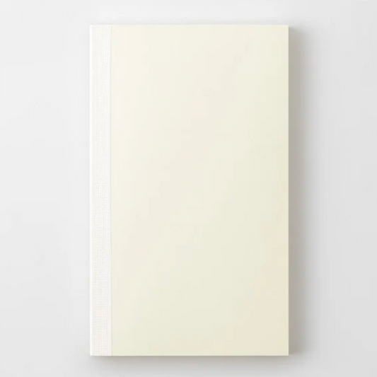 A cream-colored hardcover notebook with a textured spine, shown flat against a light gray background.
