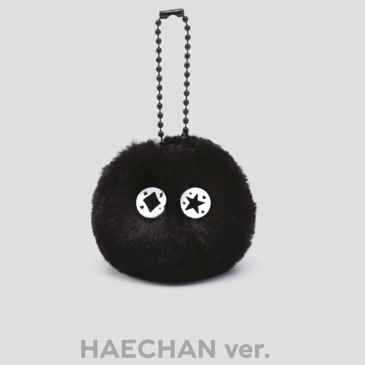 Haechan version of black fluffy keychain with cartoon face on a white background