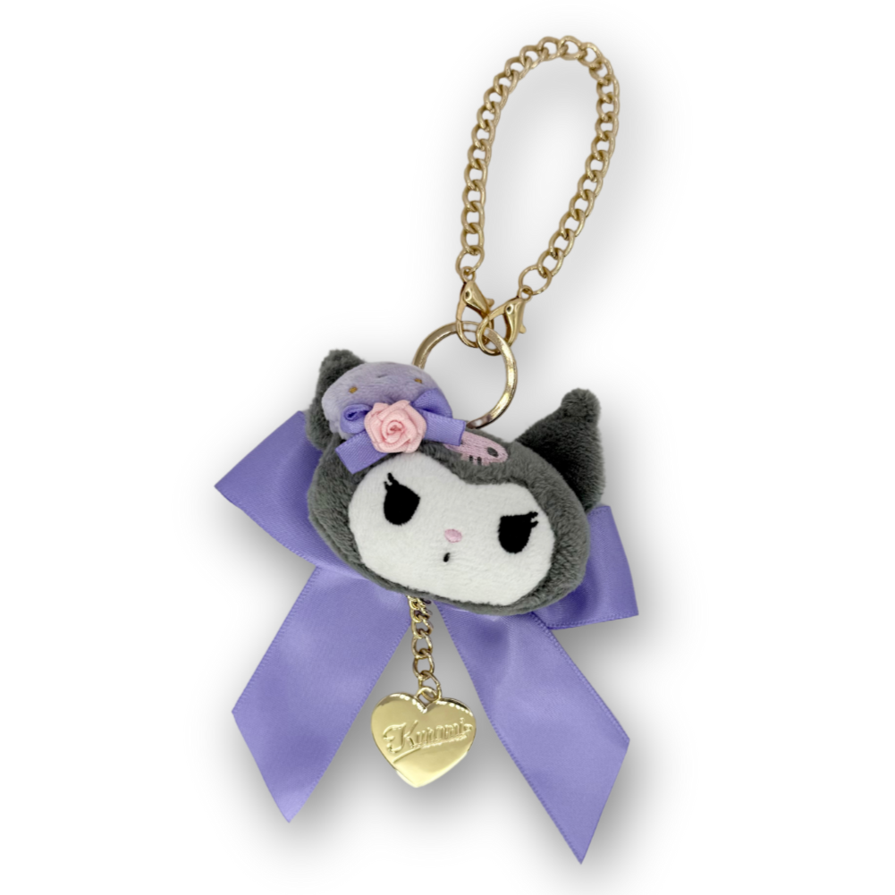 Plush keychain with a purple bow and gold heart tag on a white background