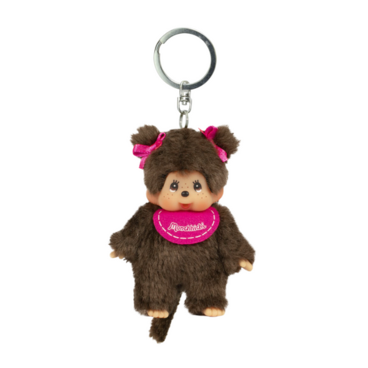 A brown faux fur monkey keychain featuring an embroidered pink tag with the text 'Monchhichi'.