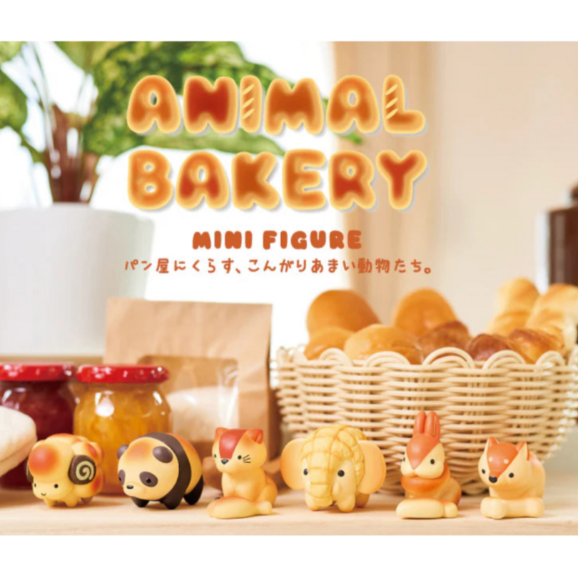 A collection of cute, animal-shaped mini figures arranged on a counter, with a sign reading 'ANIMAL BAKERY MINI FIGURE'.