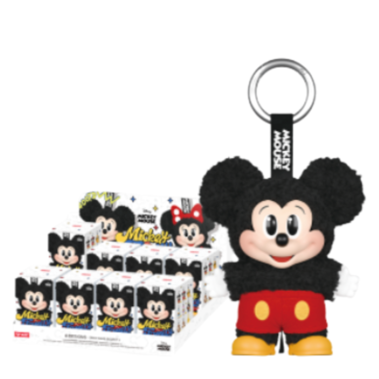 Plush keychain of a cartoon character with packaging in the background