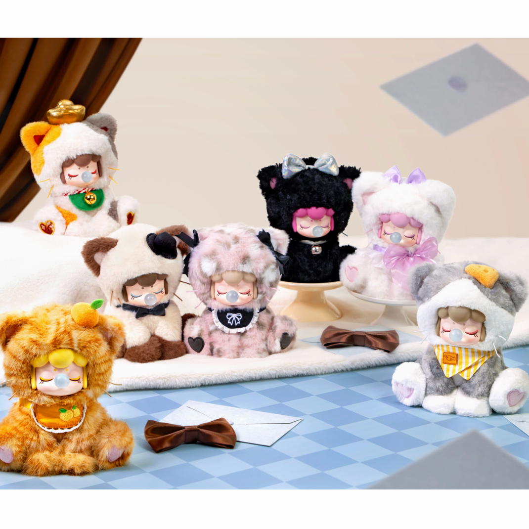 Collection of Nanci character plush toys dressed in cat costume with various designs on a checkered floor.