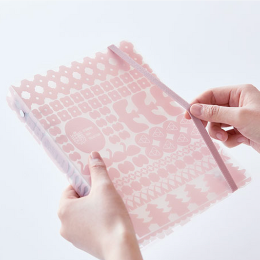 Person holding a pink and white patterned product against a light background