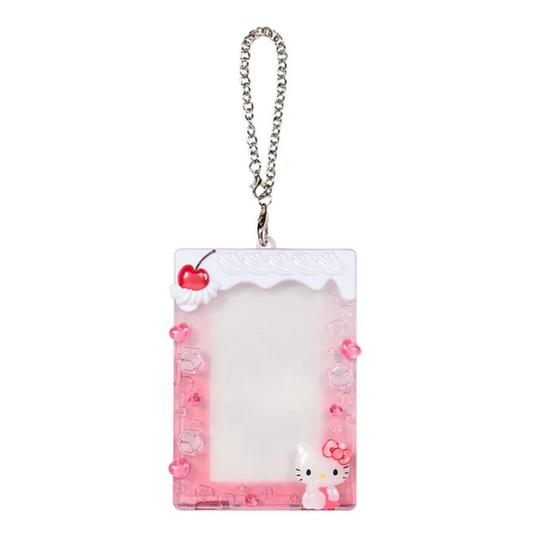 A pink and white Hello Kitty acrylic photo ID holder with a silver chain strap, decorated with 3D cherry and bow details.