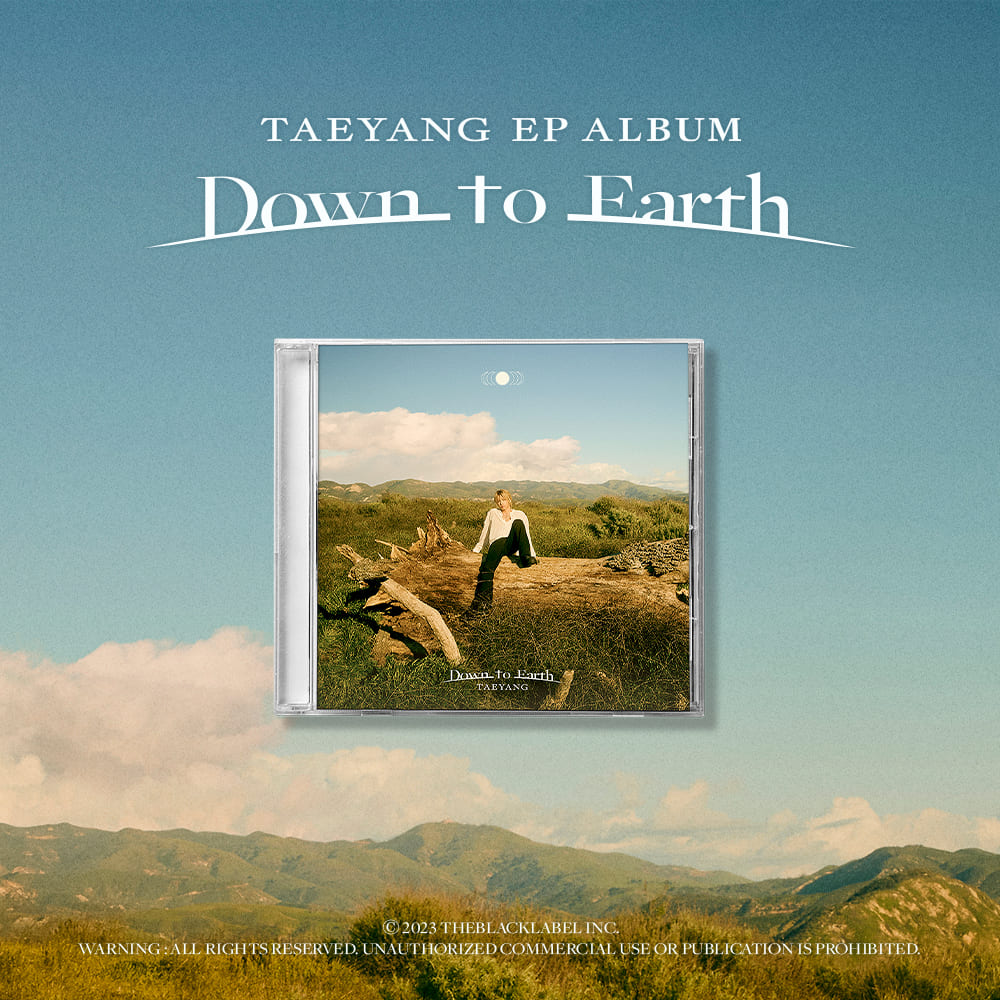 Album cover for Taeyang's EP 'Down to Earth' with a scenic landscape background.