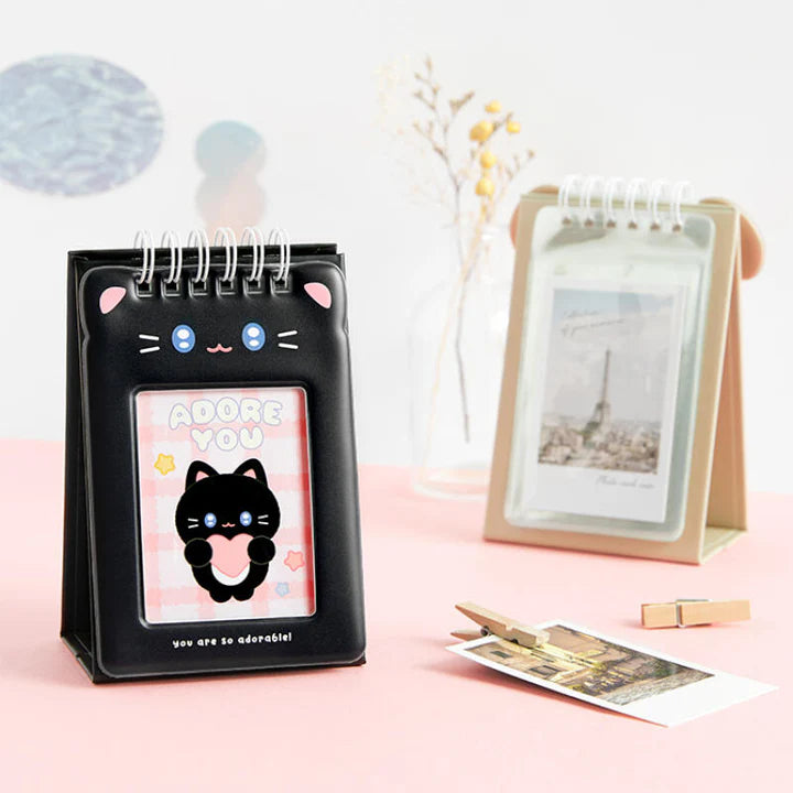 Black cat-themed desk photo card holder with a pink interior on a light pink surface.
