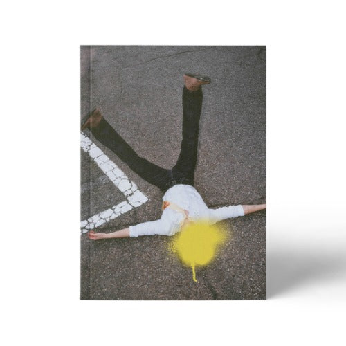 Book cover with a person lying on the ground with a yellow spray paint迹, cracked pavement background