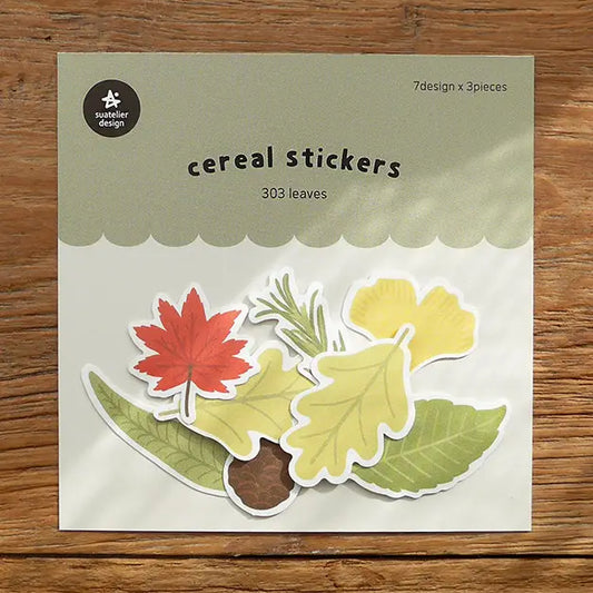 Packaging of leaf-shaped cereal stickers on a wooden surface