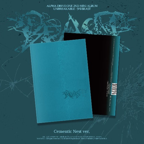 Cementic Nest ver. Alpha Drive One 2nd Mini Album Unbreakable: J*BEAST, featuring a turquoise blue front cover and a black inner sleeve on a dark teal textured background with stylized logo graphics.