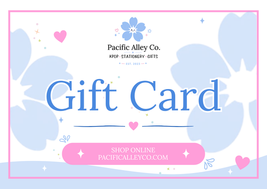 A pastel gift card design with the text 'Gift Card' in large blue letters, 'Pacific Alley Co. KPOP STATIONERY GIFTS' above, and a pink button reading 'SHOP ONLINE PACIFICALLEYCO.