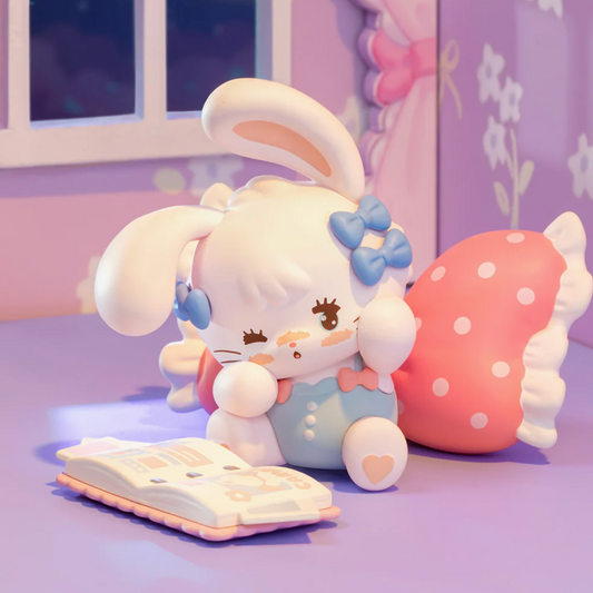 Cute plush toy with bunny ears and bow tie sitting next to a pink polka dot mushroom on a purple surface.