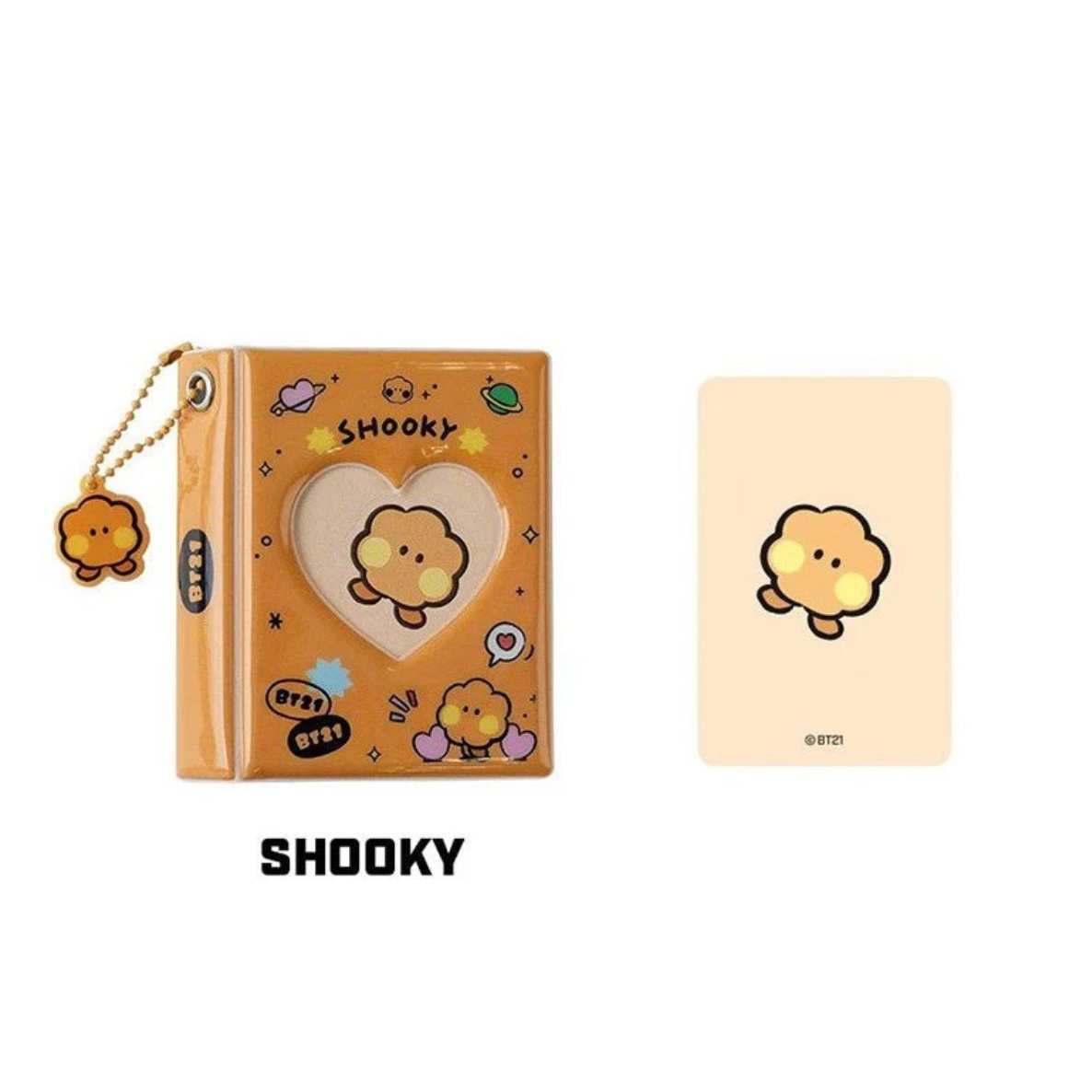 Brown photo album with heart window, and ball keychain with BT21 cartoon character 'SHOOKY' branding on a white background