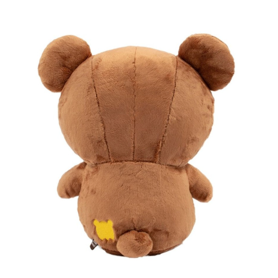 Back of brown teddy bear plush toy on a white background