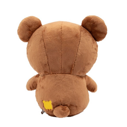 Back of brown teddy bear plush toy on a white background