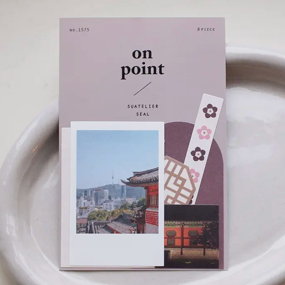Pack of stickers titled 'on point' by Suatelier Seal on a white plate