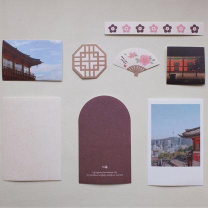 Collection of stickers and stationery items on a light gray surface