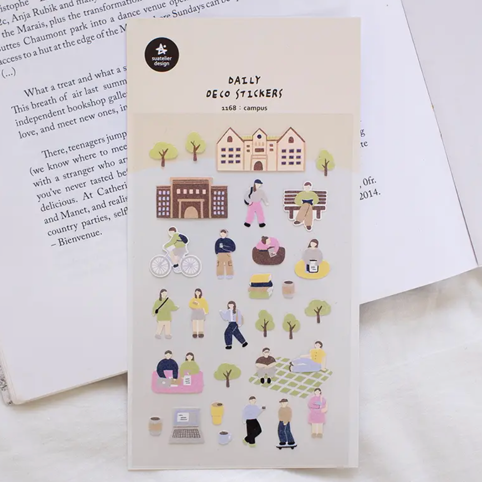 stickers with illustrations on a surface with a book in the background