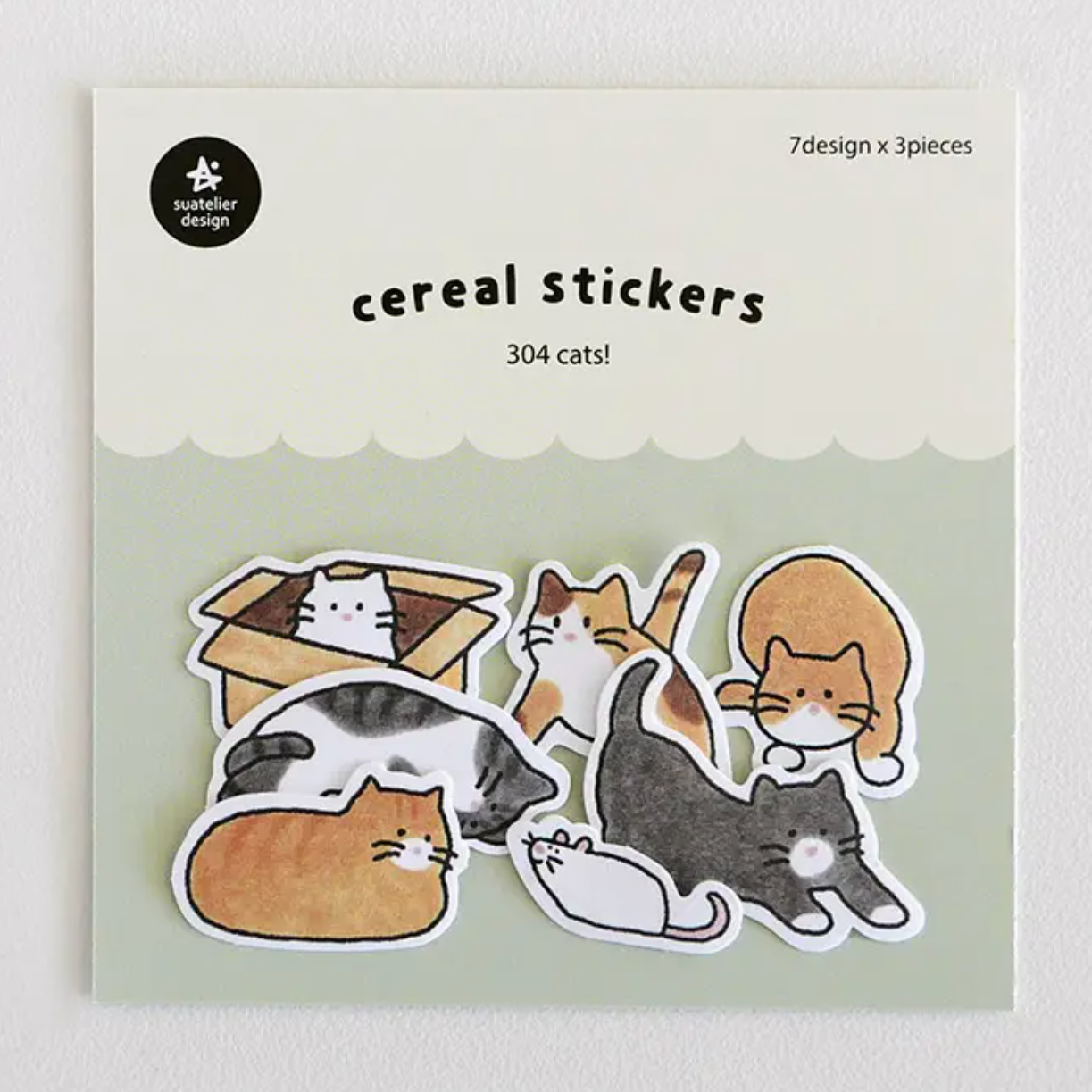 Packaging of cereal stickers with cat illustrations on a light green background