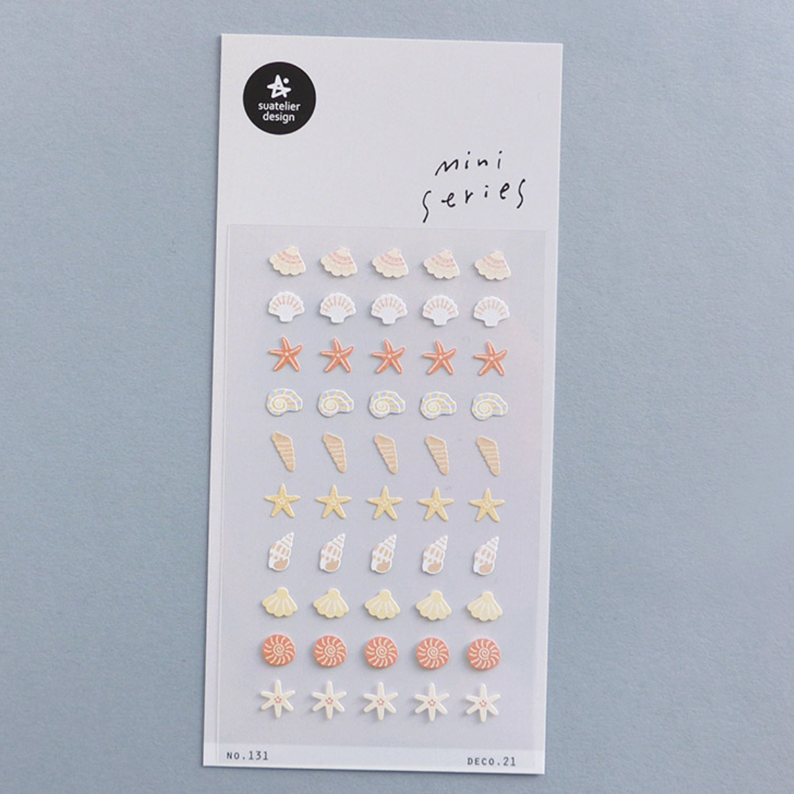 Sheet of mini stickers with starfish and shell designs on a gray background