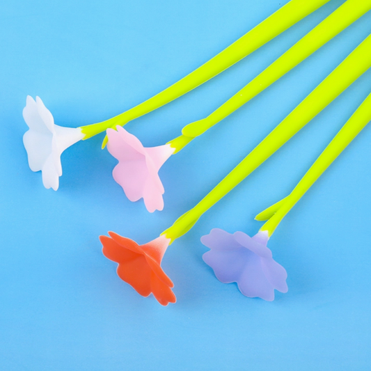 Colorful flower-shaped stir sticks on a blue background