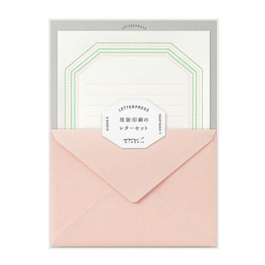 Set of stationery items including a pink envelope and letterpress cards on a white background