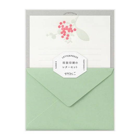 Green envelope with a white card featuring floral design and 'Letterpress' label on a white background